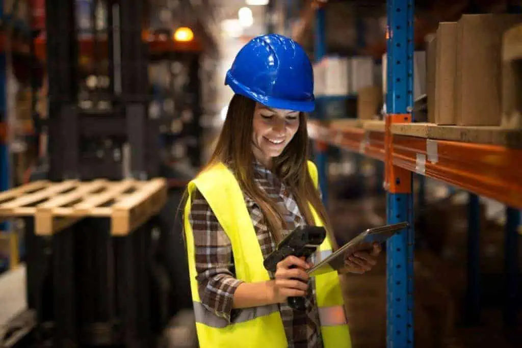 smiling female worker holding tablet bar code scanner checking inventory distribution warehouse 1024x683 1