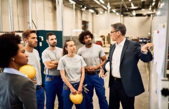 mid-adult-businessman-giving-presentation-group-industrial-workers-factory